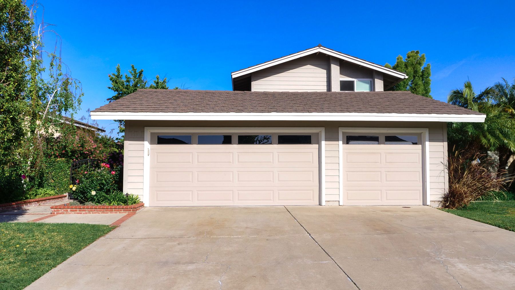 A single-story home with a broad roof, landscaped garden, and clear view of the front elevation.